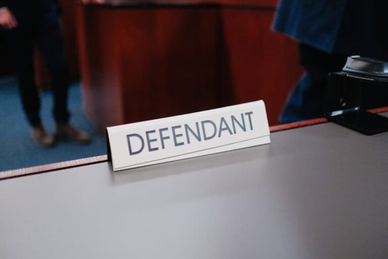 Defendant nameplate on courtroom table.