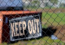 Maryland Sends Second Round of Cease-and-Desist Letters to Chumba & LuckyLand Slots Keep Out sign hanging on a chain-link fence