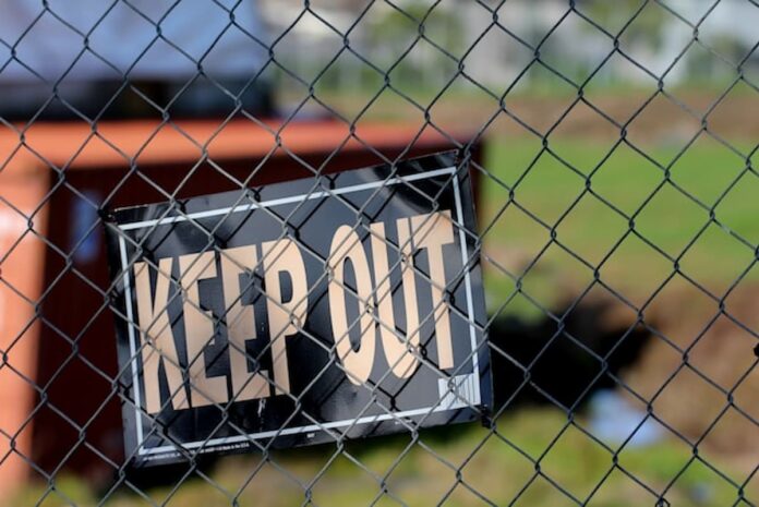 Maryland Sends Second Round of Cease-and-Desist Letters to Chumba & LuckyLand Slots Keep Out sign hanging on a chain-link fence