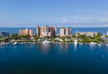Lee County Raids Net 134 Slot Machines, $22K Amid Florida’s Arcade Crackdown Aerial view of the Lee County waterfront with marinas and high-rise buildings along the Gulf Coast of Florida.