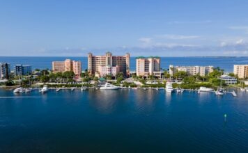 Lee County Raids Net 134 Slot Machines, $22K Amid Florida’s Arcade Crackdown Aerial view of the Lee County waterfront with marinas and high-rise buildings along the Gulf Coast of Florida.