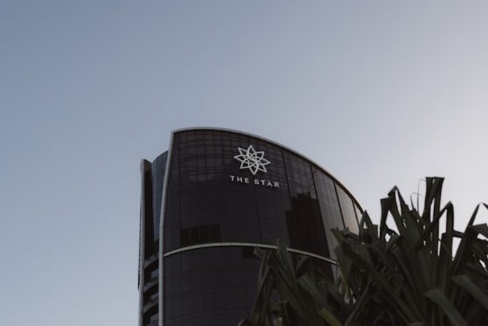 Bally’s Cleared to Take Over Star Entertainment as Regulators Approve Strategic Investment Glass tower building at dusk with a clear sky above