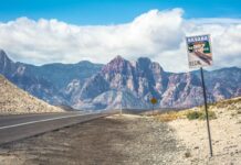 Robinhood Halts Nevada Sports-Event Contracts as Legal Pressure Mounts Nevada desert highway with scenic byway sign and mountains in the background
