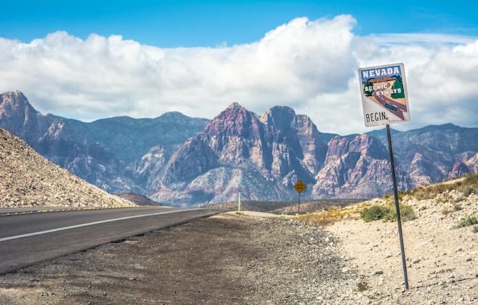 Nevada Desert Highway Nevada desert highway with scenic byway sign and mountains in the background