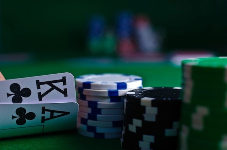 Poker chips and playing cards on a table during a high-stakes game