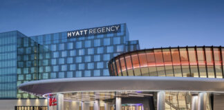 Mamdani’s Win Comes as New York Wraps Up Downstate Casino Licensing Process Rendering of the Resorts World New York City at Aqueduct Racetrack, showing the connected Hyatt Regency hotel and main casino entrance at dusk.