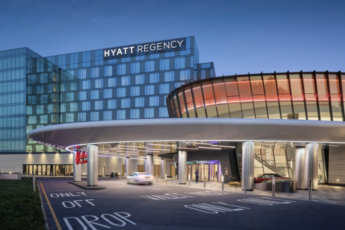 Mamdani’s Win Comes as New York Wraps Up Downstate Casino Licensing Process Rendering of the Resorts World New York City at Aqueduct Racetrack, showing the connected Hyatt Regency hotel and main casino entrance at dusk.