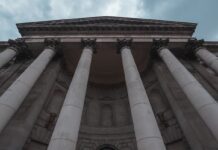 CFTC Details How it Reviews Sports Event Contracts in Response to Senators’ Questions A large stone courthouse with tall columns under a blue sky