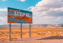 Welcome to Utah road sign in desert landscape under bright blue sky