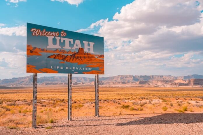 Welcome to Utah road sign in desert landscape under bright blue sky