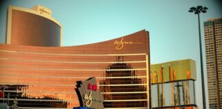 How a Secret Chinese Money Pipeline Through Wynn Las Vegas was Finally Exposed Wynn Macau exterior reflecting golden light at sunset.