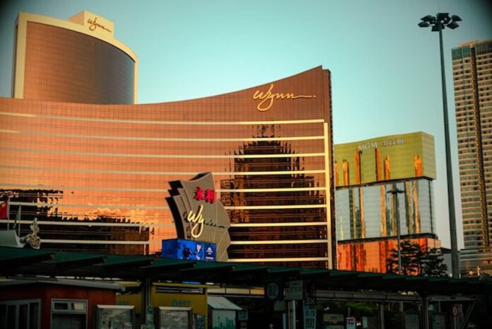 How a Secret Chinese Money Pipeline Through Wynn Las Vegas was Finally Exposed Wynn Macau exterior reflecting golden light at sunset.