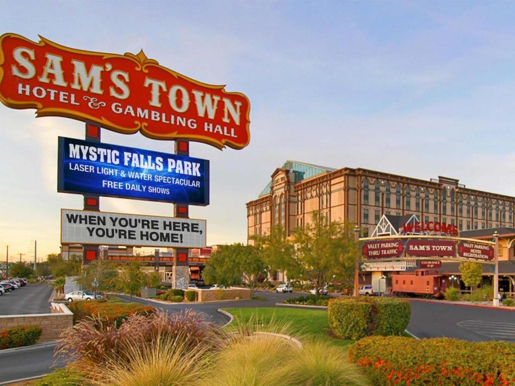 Daytime view of Sam’s Town Hotel & Gambling Hall with signage and landscaping
