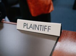 Sports Betting Alliance Sues Chicago Over City Gambling Tax Close-up photo of a plaintiff sign on a table