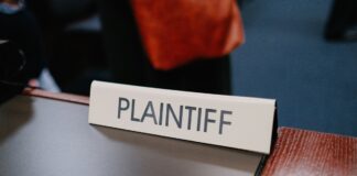 Sports Betting Alliance Sues Chicago Over City Gambling Tax Close-up photo of a plaintiff sign on a table