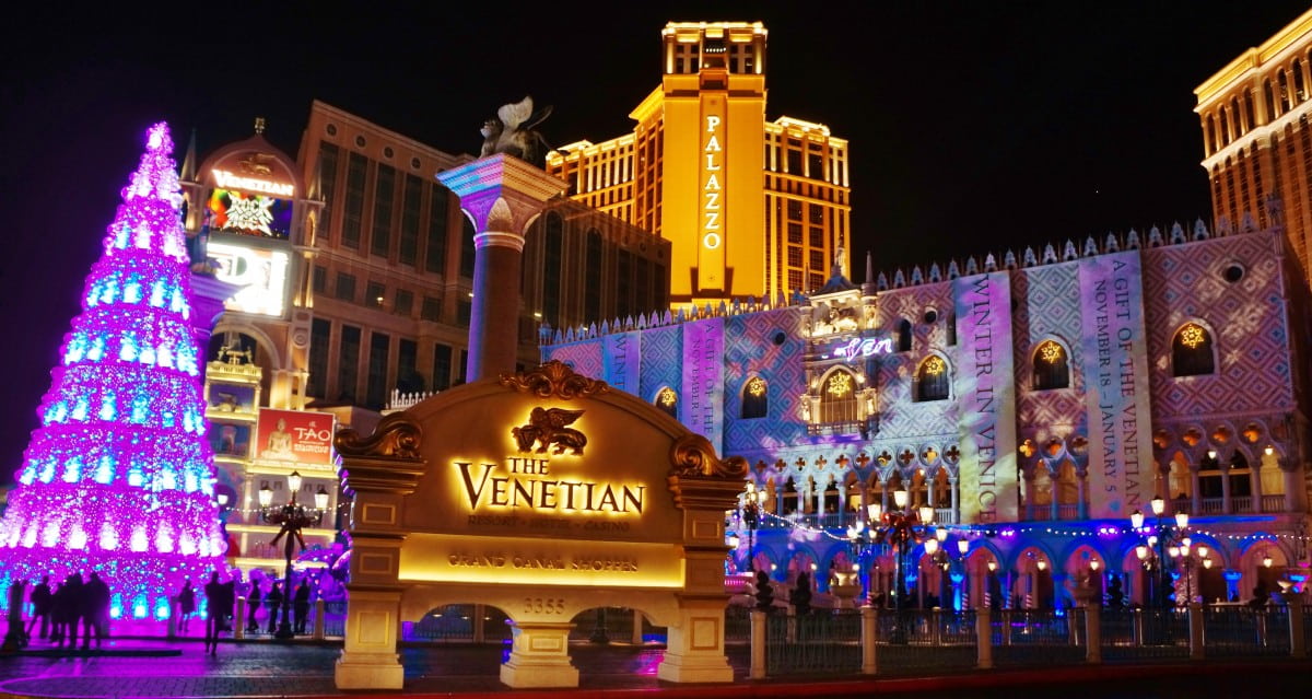 The Venetian Resort decorated with festive lights and a glowing Christmas tree
