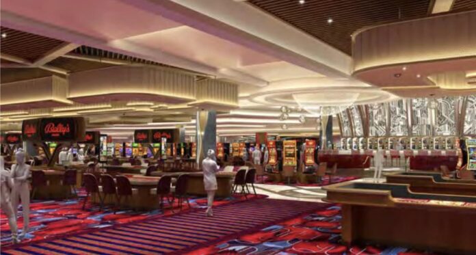 Bally’s Secures $1.1B Financing as New Chicago Casino Renderings Debut, Boosting New York Bid Interior rendering of Bally’s Chicago casino showing table games, slot machines, patterned carpeting, and decorative ceiling lighting across a large open gaming floor.