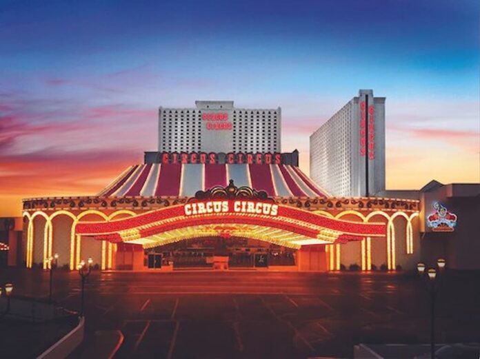 Circus Circus Bets on Nostalgia With New Bingo Hall & Expanded Coin-Operated Slots Exterior view of Circus Circus Las Vegas at dusk, showing the illuminated marquee and hotel towers