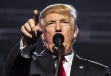 Trump Sidesteps Question on Eliminating Federal Tax on Gambling Winnings Donald Trump speaking at a rally, pointing forward while addressing the audience from behind a microphone.