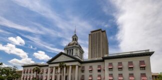 Old Florida State Capitol with red-and-white awnings and the modern Capitol tower in Tallahassee under a bright sky, representing new state gambling legislation.