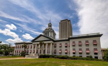 Old Florida State Capitol with red-and-white awnings and the modern Capitol tower in Tallahassee under a bright sky, representing new state gambling legislation.
