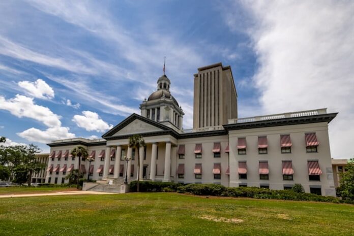 Florida Files Second Major Anti-Gambling Bill, as Lawmakers Move Toward Full-Scale Crackdown Old Florida State Capitol with red-and-white awnings and the modern Capitol tower in Tallahassee under a bright sky, representing new state gambling legislation.