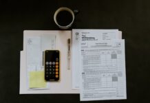 IRS Raises Slot Jackpot Tax Reporting Threshold to $2,000 Ahead of 2026 Calculator, tax forms, envelopes, and paperwork arranged on a desk related to U.S. tax filing