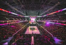 Fans fill a large indoor arena during a professional basketball game.