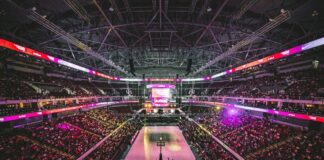Fans fill a large indoor arena during a professional basketball game.