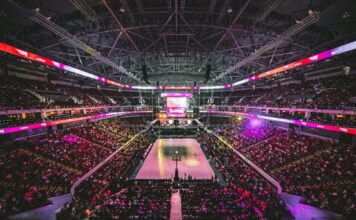 Most Americans Say Sports Betting Undermines Integrity of Games, NBC Poll Finds Fans fill a large indoor arena during a professional basketball game.