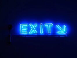 ‘The Pulse’ on Sweepstakes Casinos Amid US Legal Scrutiny & Model Shifts Blue neon “Exit” sign with an arrow pointing right against a dark background