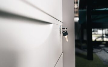 Close-up of a locked office drawer with a key hanging from the lock