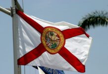 SGLA Pushes for Sweepstakes Casino Legalization in Florida Despite Major Barriers The Florida state flag waving against a blue sky