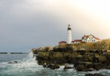 Portland Head Light on a rocky Maine coastline with waves crashing below