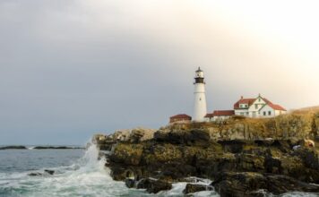 Portland Head Light on a rocky Maine coastline with waves crashing below