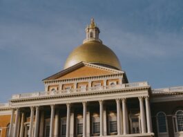 Massachusetts Treasurer Pushes Back on iGaming as iLottery Nears Launch The Massachusetts State House in Boston with its gold dome and columned facade under a clear sky