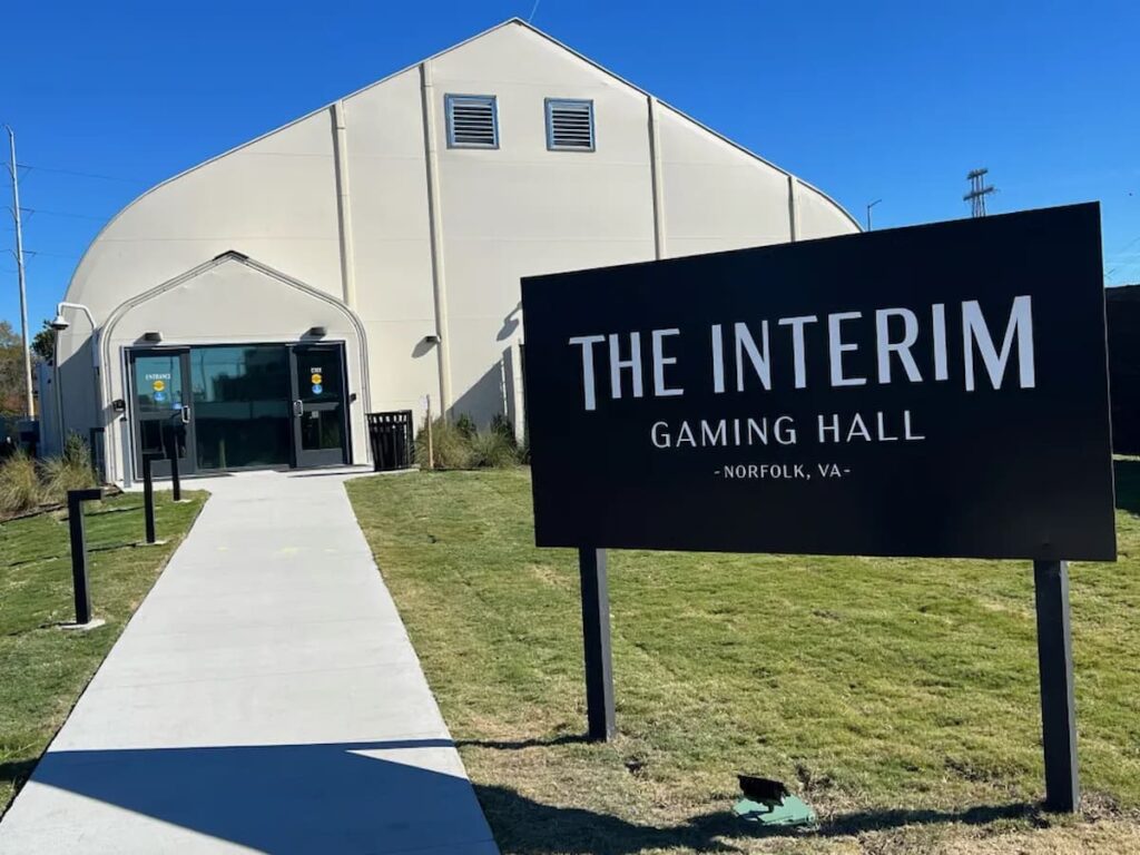Sign outside the Interim Gaming Hall temporary casino in Norfolk, Virginia, showing the entrance to the slot-only gaming facility.