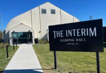 Sign outside the Interim Gaming Hall temporary casino in Norfolk, Virginia, showing the entrance to the slot-only gaming facility.