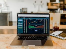 Prediction Markets: FanDuel Launches FanDuel Predicts as Coinbase Acquires The Clearing Company Laptop displaying financial trading charts on a desk
