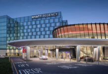 Resorts World Seeks Standardized Tax Rate Across New York Casinos Rendering of the Resorts World New York City at Aqueduct Racetrack, showing the connected Hyatt Regency hotel and main casino entrance at dusk.
