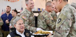 Texas Governor Greg Abbott ‘Not There Yet’ on Casino Gambling in Lone Star State Texas Governor Greg Abbott serving food to uniformed service members during a visit with troops.