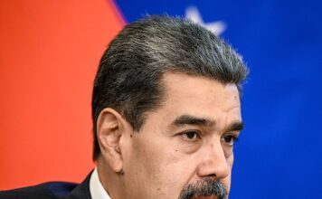 Venezuelan President Nicolás Maduro speaking during a formal meeting, wearing a dark suit and patterned tie.