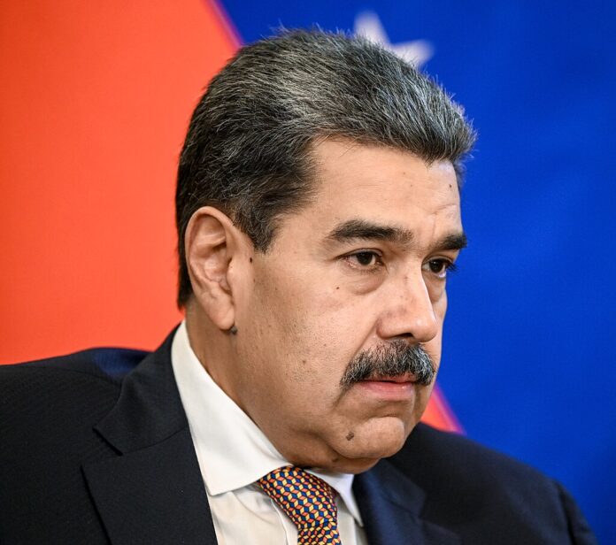 Polymarket Faces Backlash After Saying Venezuela Wasn't Invaded Venezuelan President Nicolás Maduro speaking during a formal meeting, wearing a dark suit and patterned tie.