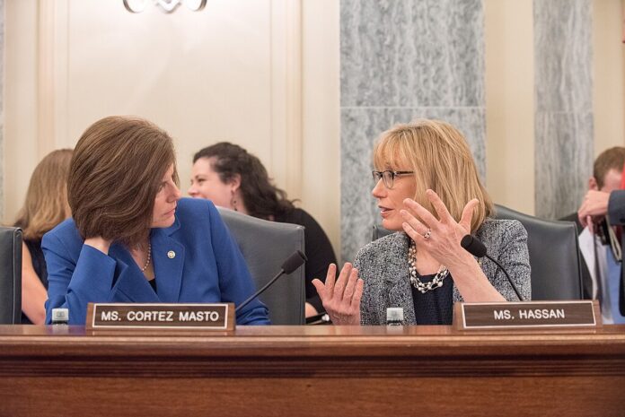 U.S. Sen. Catherine Cortez Masto speaks with Sen. Maggie Hassan during a Senate committee hearing in Washington, D.C.