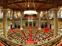 New York Bill Targets Insider Trading on Prediction Markets & Sportsbooks Interior of the New York State Assembly chamber in Albany during a legislative session.