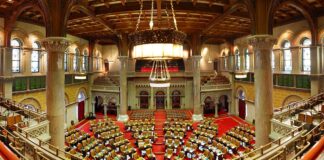 New York Bill Targets Insider Trading on Prediction Markets & Sportsbooks Interior of the New York State Assembly chamber in Albany during a legislative session.