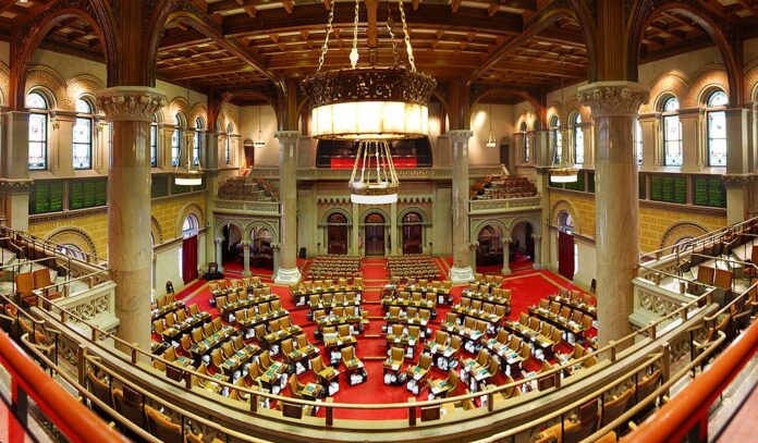 Interior of the New York State Assembly chamber in Albany during a legislative session.