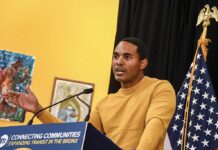 Rep. Ritchie Torres speaks at a podium during a Penn Access project event, with a U.S. flag visible behind him.