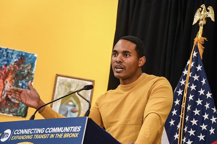 Rep. Torres Introduces Bill Barring Federal Officials From Insider Trading on Prediction Markets Rep. Ritchie Torres speaks at a podium during a Penn Access project event, with a U.S. flag visible behind him.