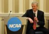 March Madness: Senators Accuse NCAA of Profiting From Selling Gambling Data to Sportsbooks NCAA President Charlie Baker speaks into a microphone while seated beside an NCAA-branded podium at a conference event.